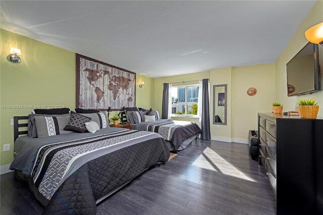 bedroom with dark hardwood / wood-style floors