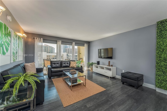 living room with baseboards and dark wood-style flooring