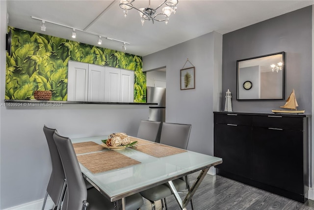 dining area featuring baseboards, a notable chandelier, and dark wood-style floors