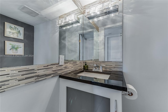 bathroom with vanity and backsplash