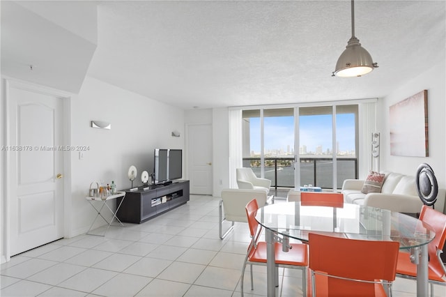 tiled dining area with a textured ceiling