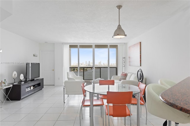 tiled dining space featuring a textured ceiling