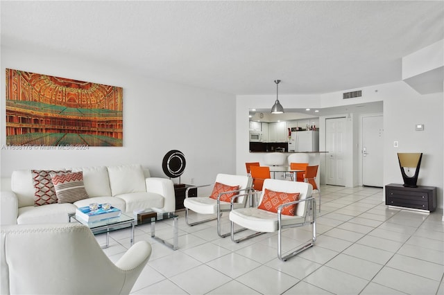 living room featuring light tile patterned floors and a textured ceiling