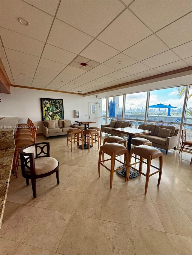 dining space with a drop ceiling