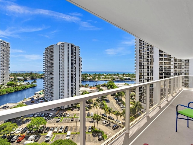 balcony featuring a water view and a city view