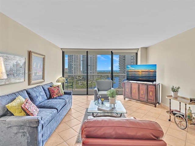 tiled living room featuring a wall of windows