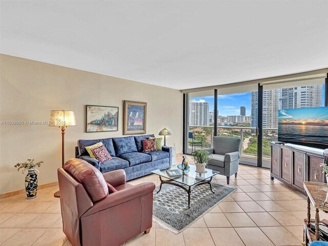 tiled living room featuring floor to ceiling windows