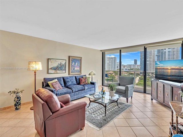 living room featuring light tile patterned floors, baseboards, and expansive windows