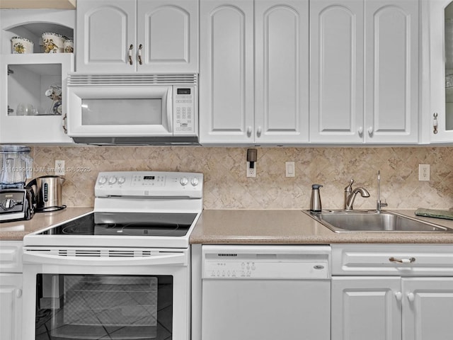 kitchen with white cabinetry, white appliances, sink, and backsplash