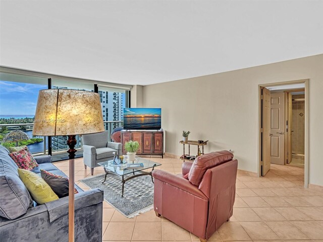 tiled living room featuring floor to ceiling windows