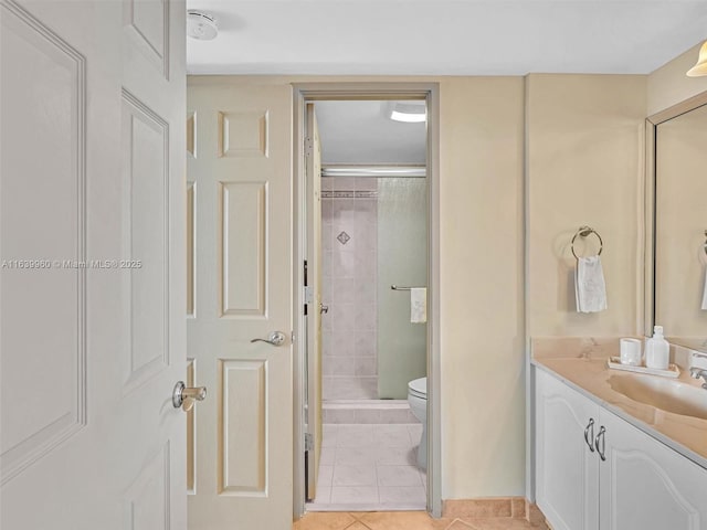 bathroom featuring vanity, tile patterned floors, toilet, and a stall shower