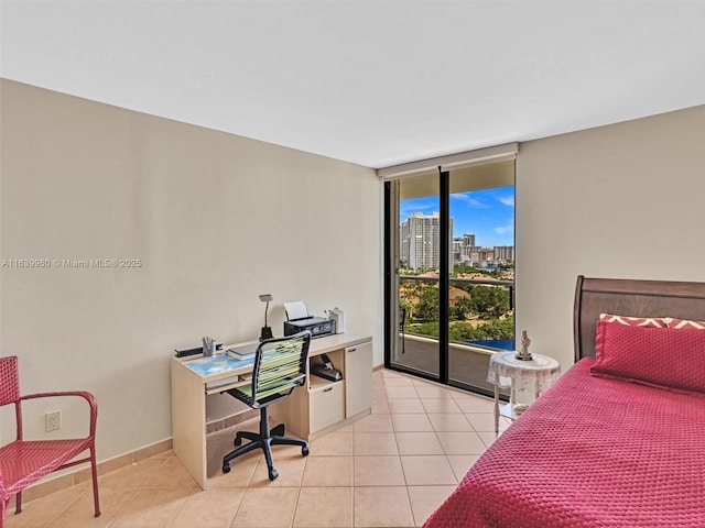 tiled bedroom featuring a wall of windows and access to exterior