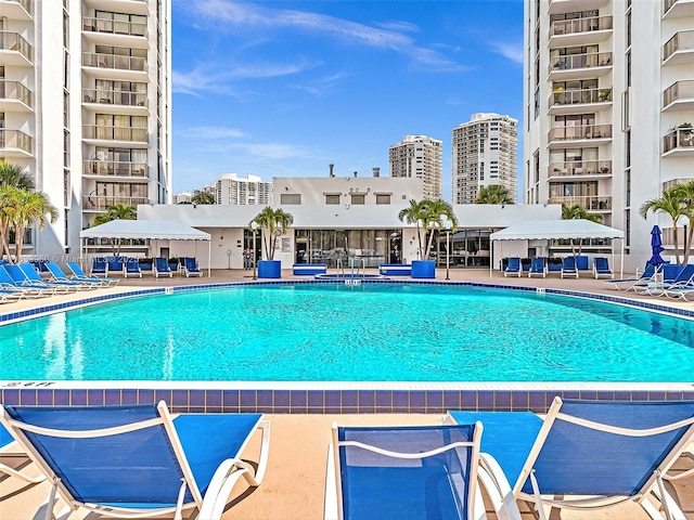 pool with a view of city and a patio area