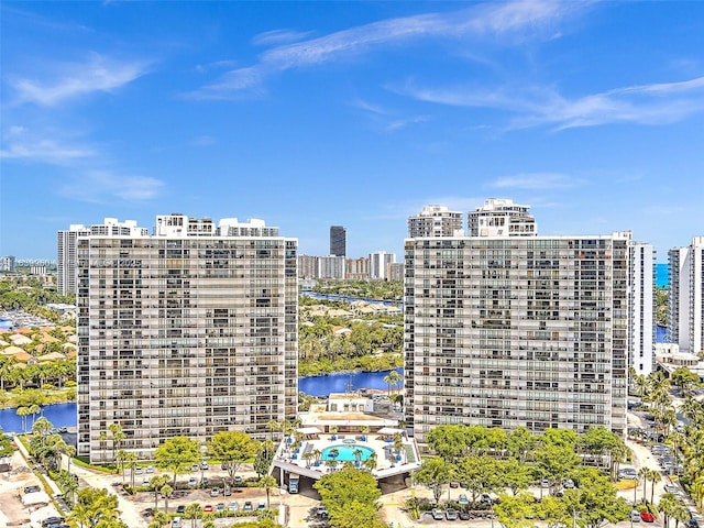 view of building exterior featuring a city view and a water view