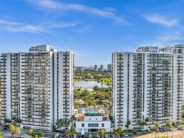 view of building exterior with a view of city and a water view