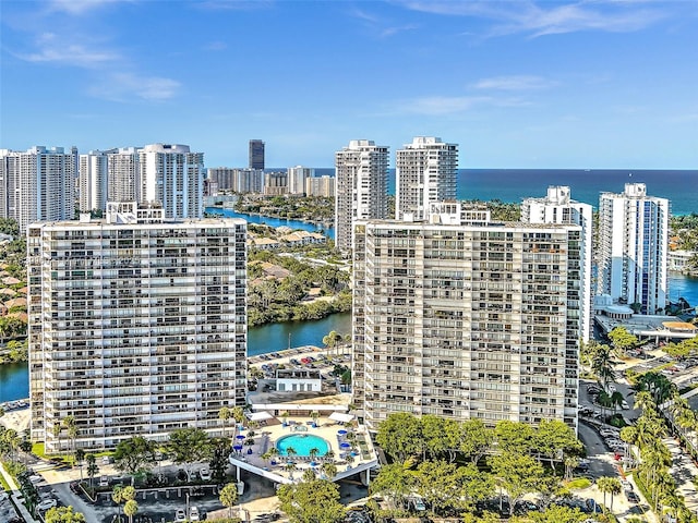 birds eye view of property with a water view and a city view