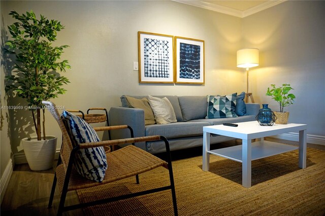 living room with ornamental molding and hardwood / wood-style floors