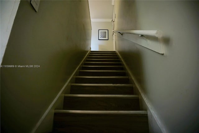 staircase featuring ornamental molding