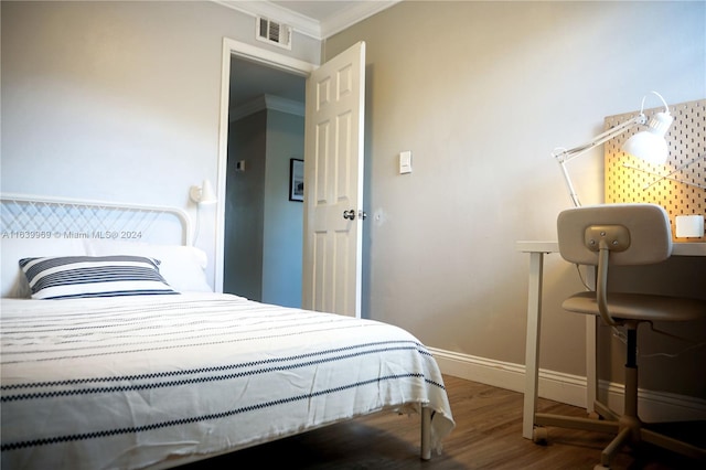 bedroom with hardwood / wood-style flooring and ornamental molding