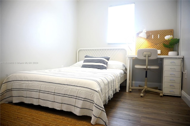 bedroom featuring dark hardwood / wood-style flooring