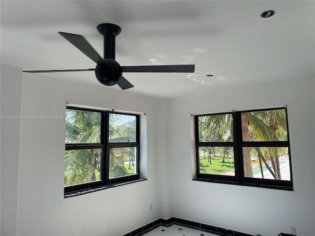 spare room featuring tile patterned flooring and ceiling fan