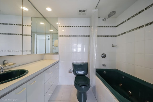 full bathroom with vanity, tile patterned floors, tile walls, toilet, and shower / bath combo