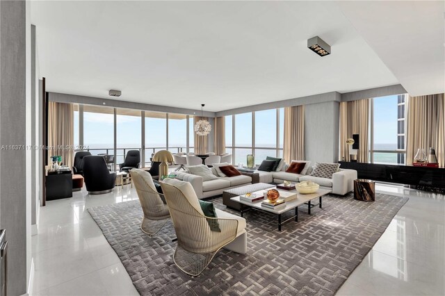 living room with a water view, tile patterned floors, and expansive windows