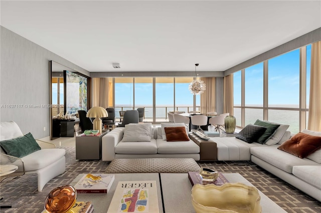 living room featuring expansive windows and a water view