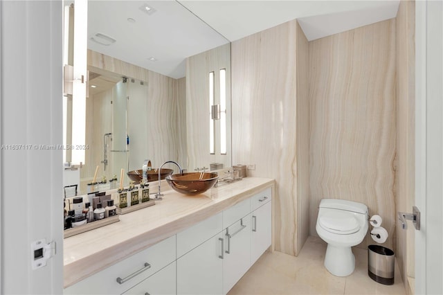 bathroom with toilet, tile patterned floors, and vanity