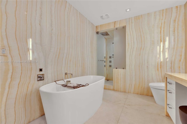 bathroom with tile patterned floors, vanity, and a washtub