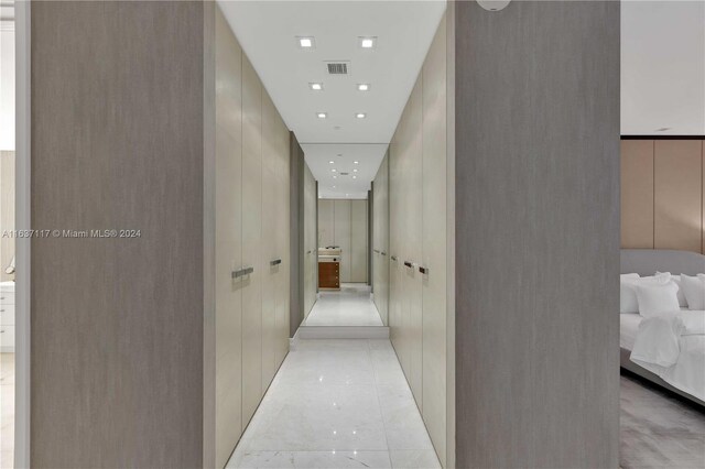 hall featuring light tile patterned floors