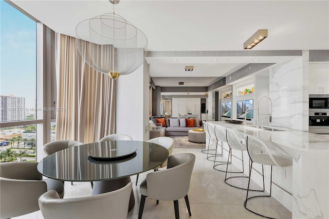 dining space with a wall of windows and sink