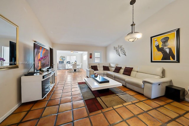 living room featuring ceiling fan, vaulted ceiling, and tile patterned flooring