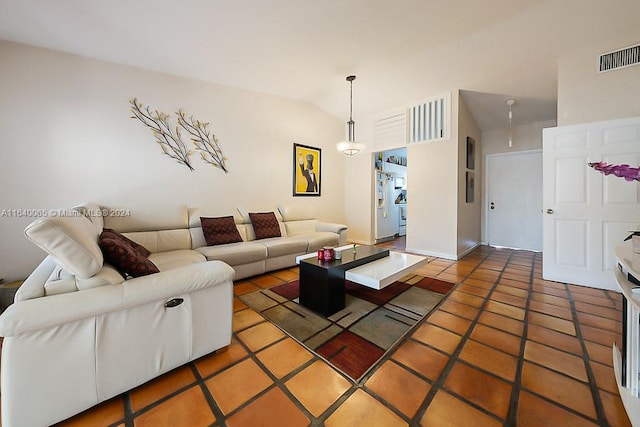 tiled living room with vaulted ceiling