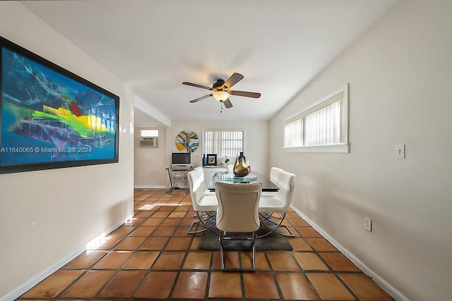 tiled dining space with an AC wall unit and ceiling fan