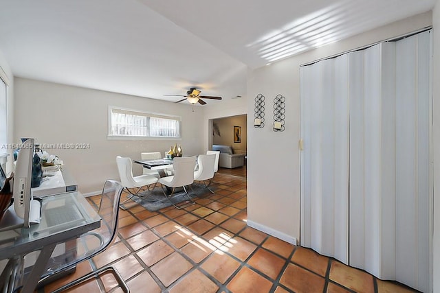 tiled office featuring ceiling fan