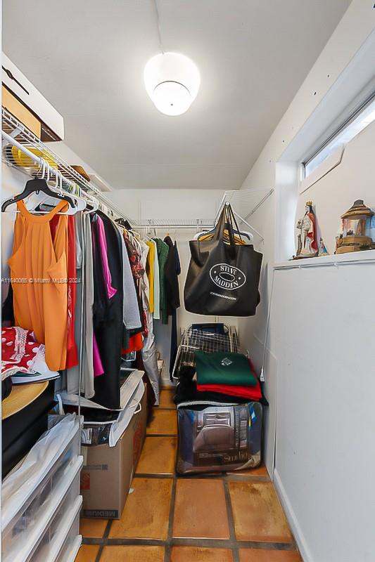 walk in closet with tile patterned flooring