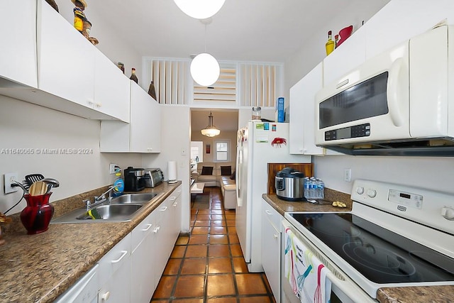 kitchen featuring sink, dark tile patterned flooring, white cabinetry, and white appliances