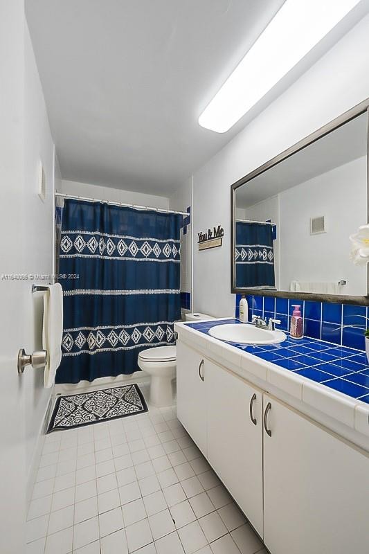 bathroom with tile patterned floors, vanity, and toilet