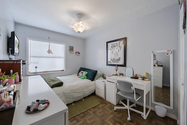 bedroom featuring dark parquet flooring