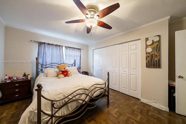 bedroom with crown molding, dark parquet floors, a closet, and ceiling fan