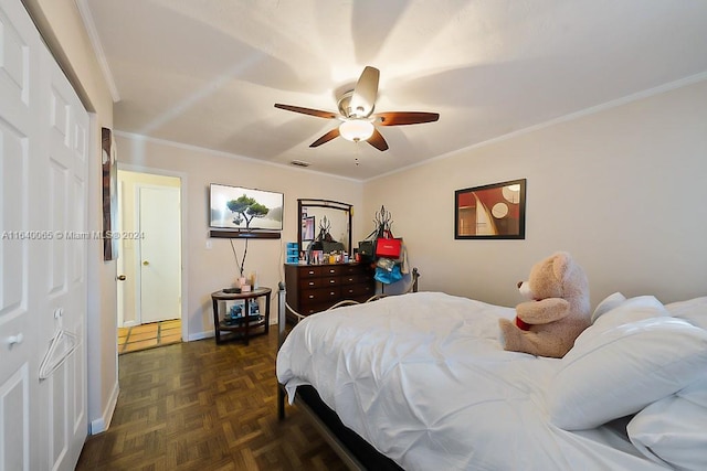 bedroom with dark parquet flooring, ornamental molding, and ceiling fan