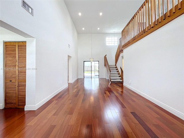 interior space featuring a high ceiling and hardwood / wood-style floors