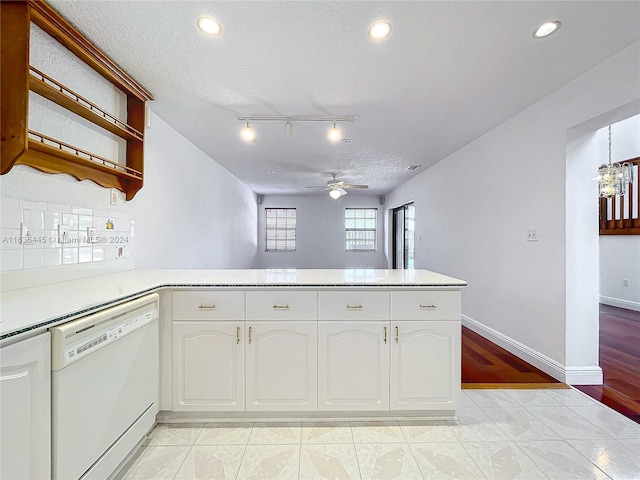 kitchen with kitchen peninsula, light tile patterned flooring, white cabinets, and dishwasher