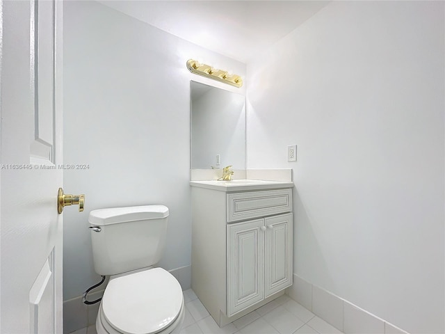 bathroom featuring tile patterned floors, vanity, and toilet