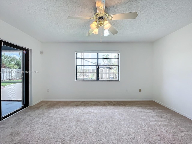 spare room with light carpet, plenty of natural light, and ceiling fan