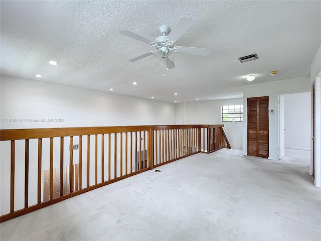 spare room with ceiling fan and a textured ceiling