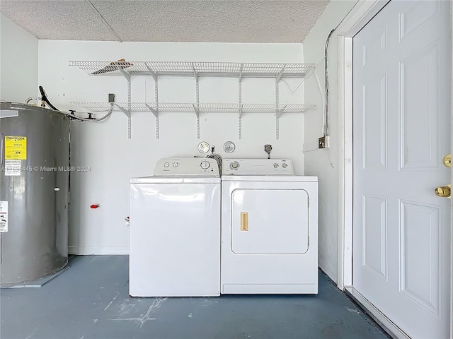 laundry area featuring water heater and washer and clothes dryer