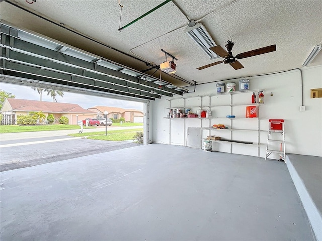 garage with ceiling fan and a garage door opener