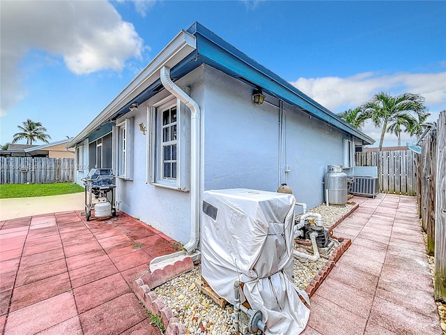 view of property exterior with a patio area and central air condition unit